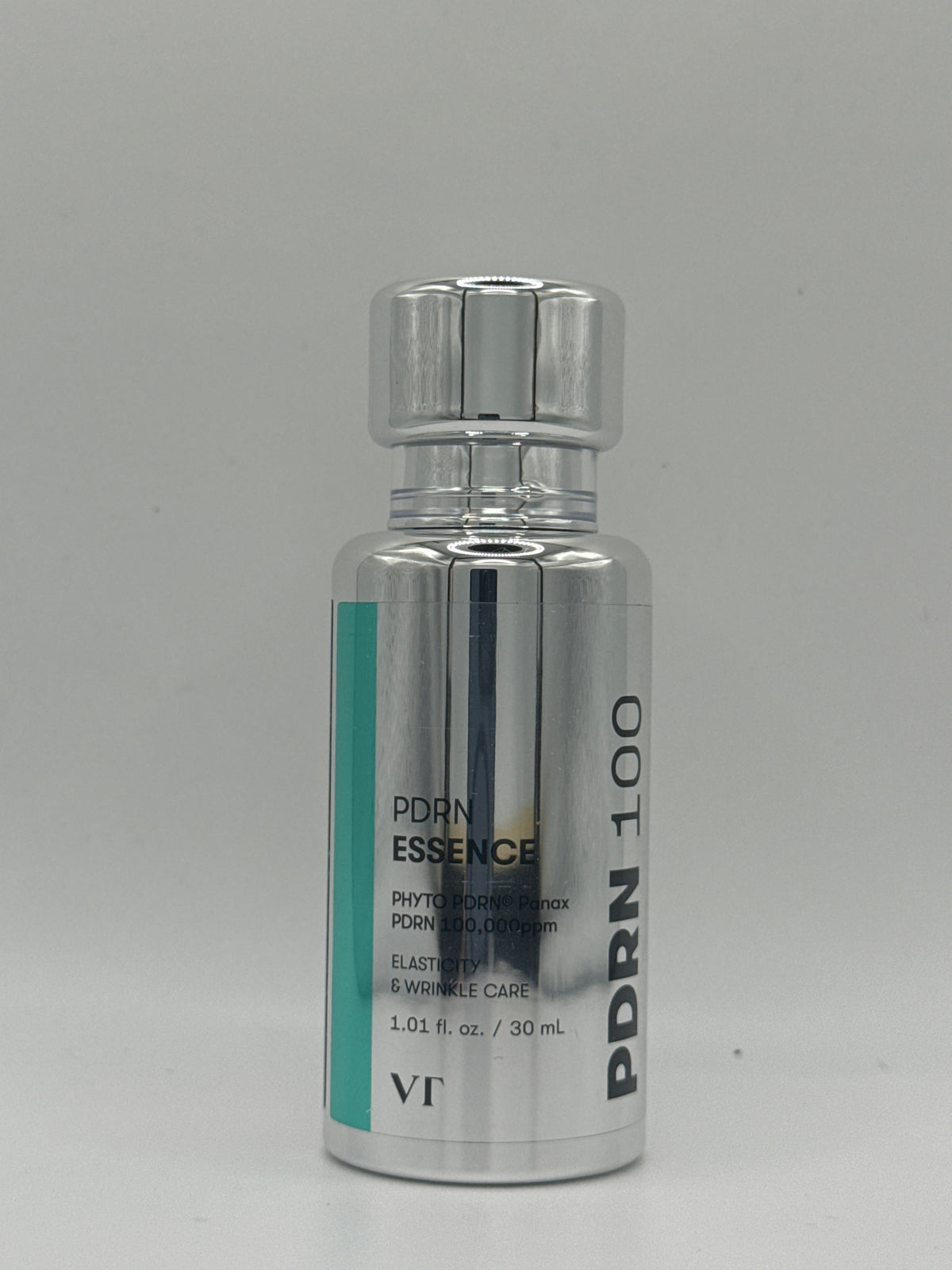 VT PDRN Essence 100 30 ml silver bottle with teal accent and silver cap, front view.