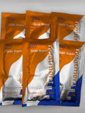 Six orange, silver, and blue sachets of Bio Gold Super Hair Treatment Cream arranged in two rows.