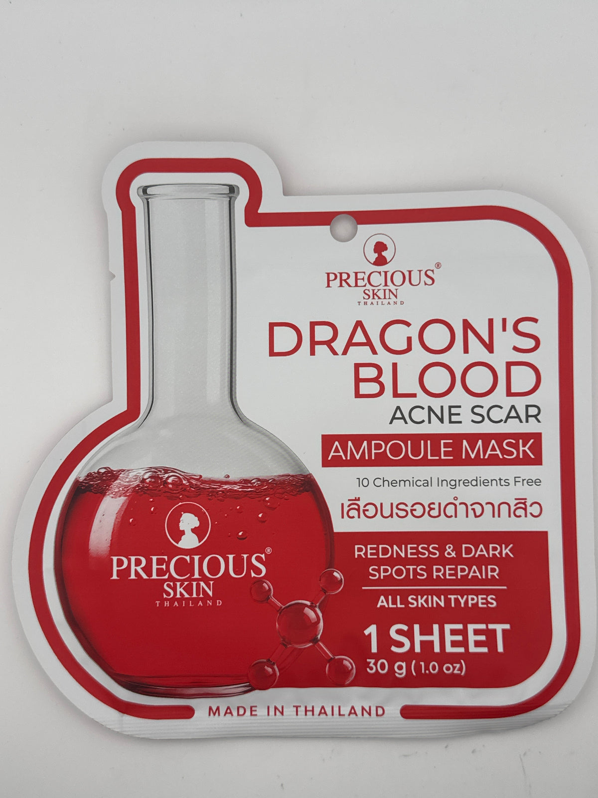 Front photo: Precious Skin Dragon’s Blood Acne Scar Ampoule Mask white and red pouch with a flask illustration, containing one 30 g sheet mask.