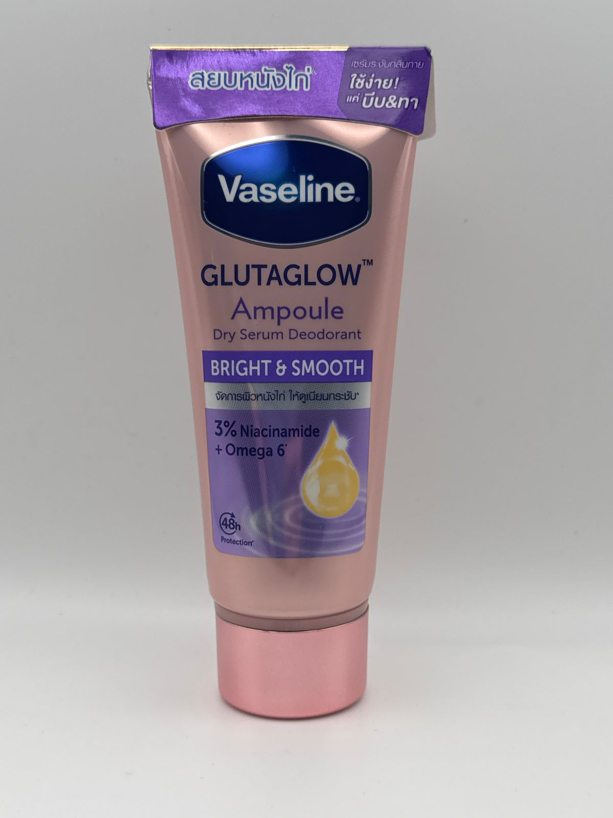 Vaseline GlutaGlow Bright & Smooth dry serum deodorant in a pink tube with purple labeling, showing 3% niacinamide and Omega 6.