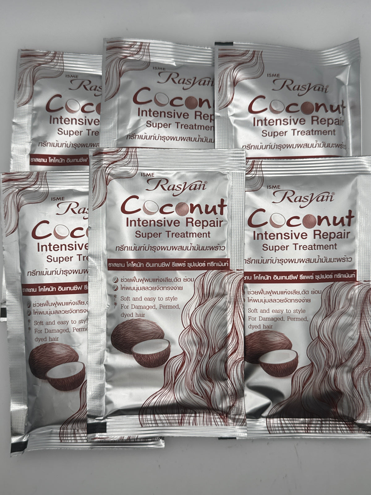Six silver sachets of Rasyan Coconut Intensive Repair Super Treatment with coconut images and flowing hair illustrations.