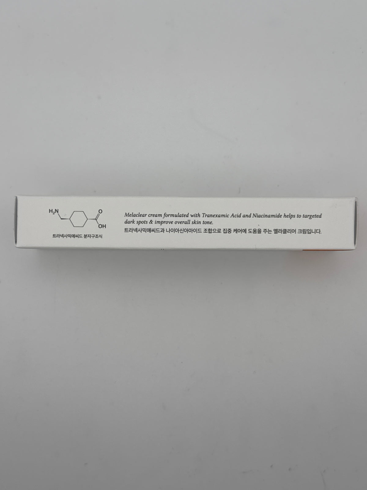 Side photo: Dr. Althea Melaclear Cream side panel showing the tranexamic acid molecular structure and dark-spot care information.