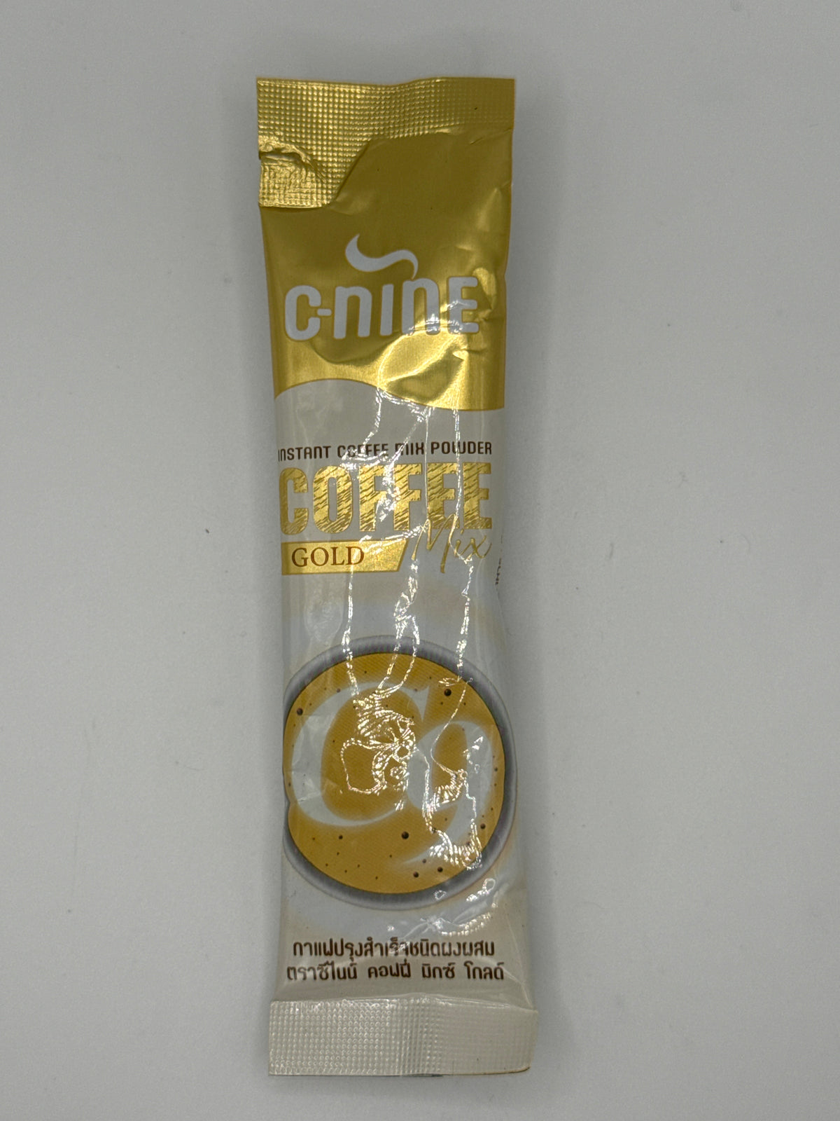 C9 Coffee Mix Gold individual gold-and-white instant coffee sachet, front view with C-Nine branding and coffee cup artwork.