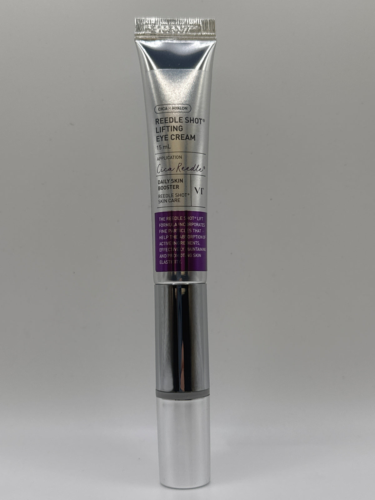 VT Reedle Shot Lifting Eye Cream 15 ml silver tube with purple labeling and capped applicator, front view.