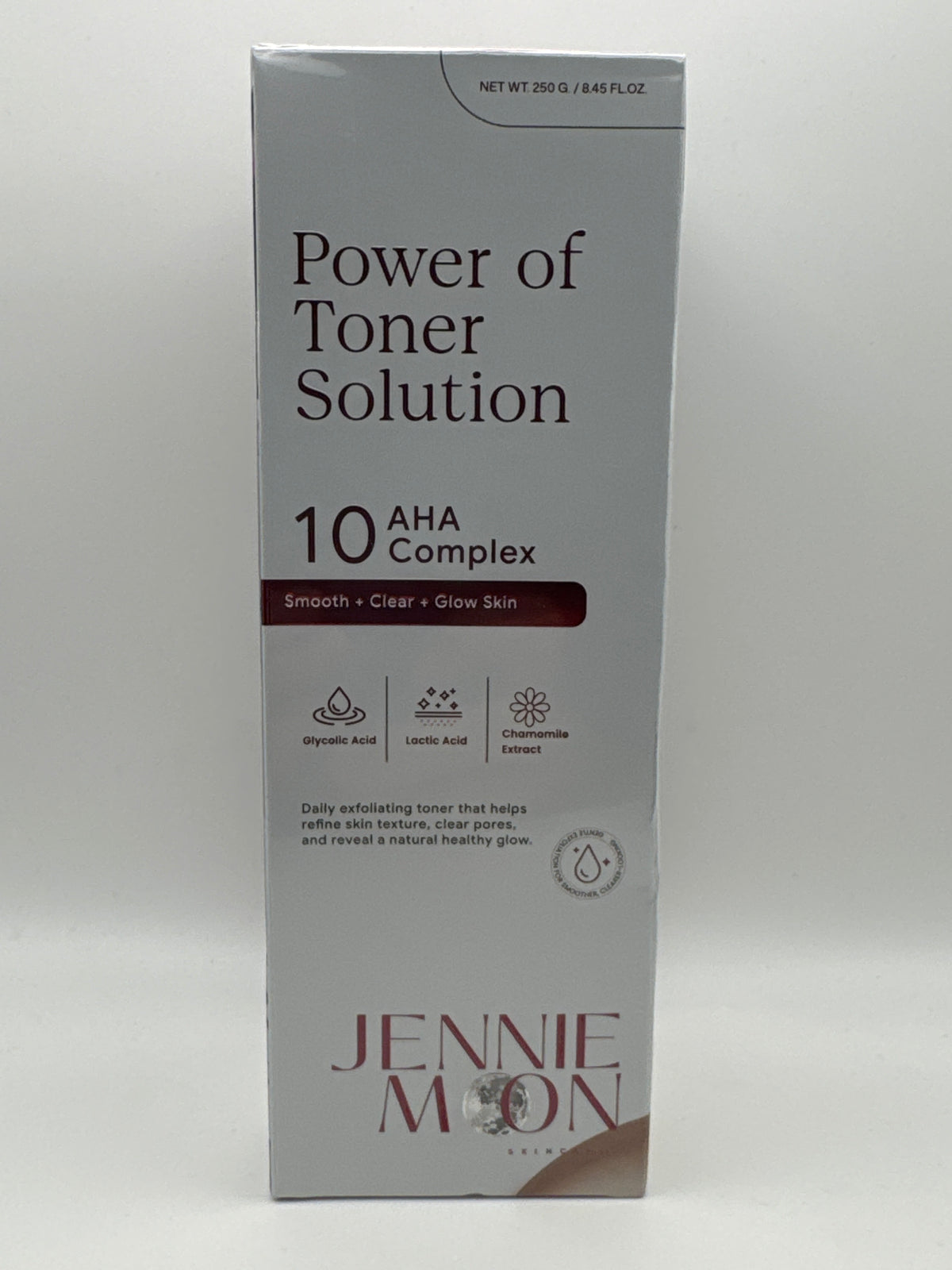 Jennie Moon Power of Toner Solution 250 g box showing the AHA Complex label and glycolic acid, lactic acid, and chamomile highlights.

