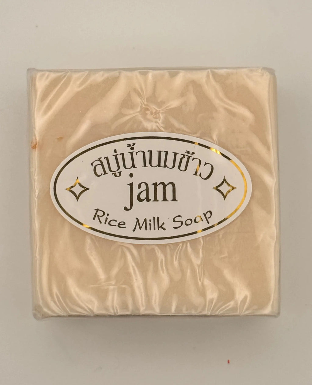"Jam Rice Milk Soap bars unwrapped showing creamy rice milk texture for brightening face and body"
