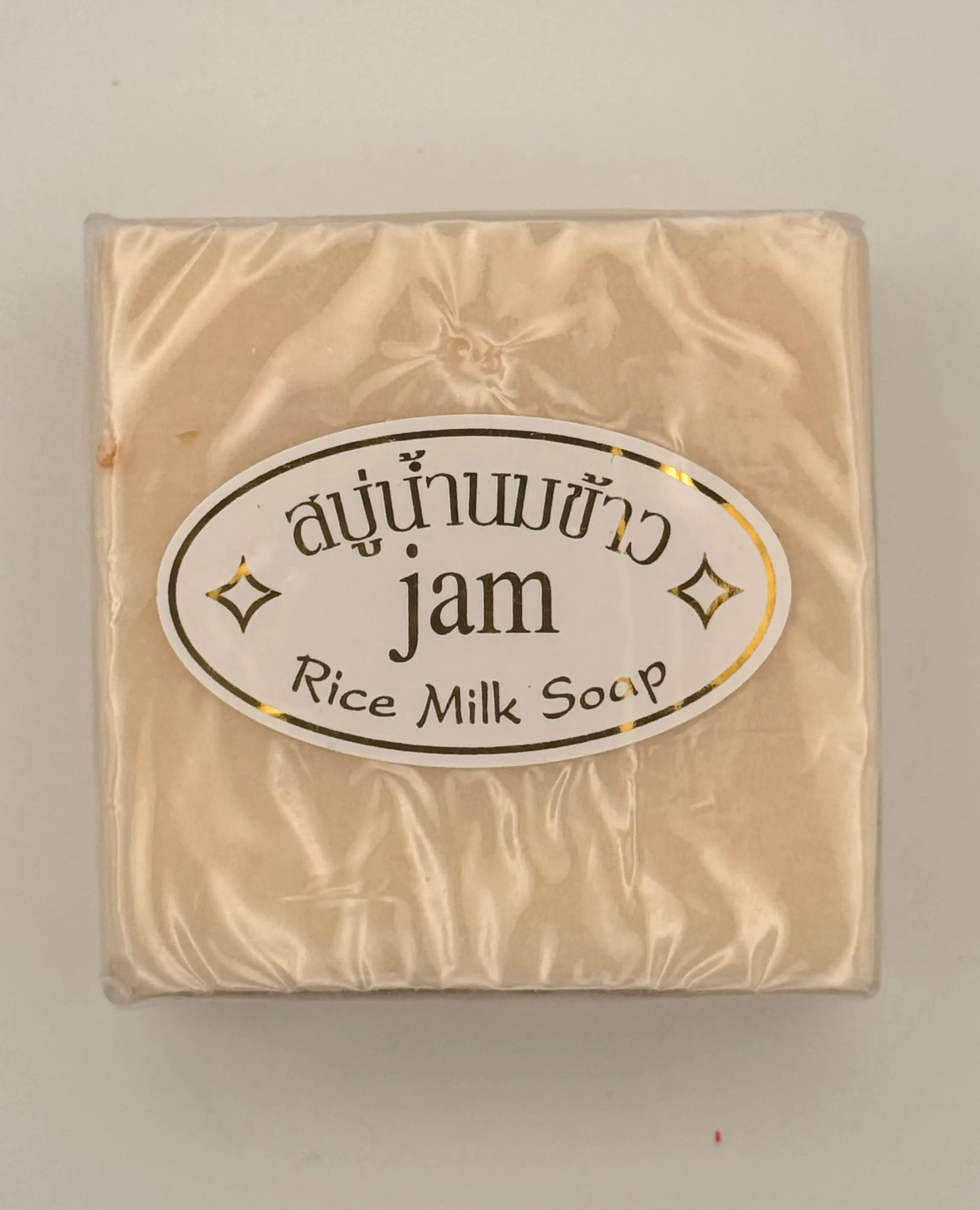 "Jam Rice Milk Soap bars unwrapped showing creamy rice milk texture for brightening face and body"

